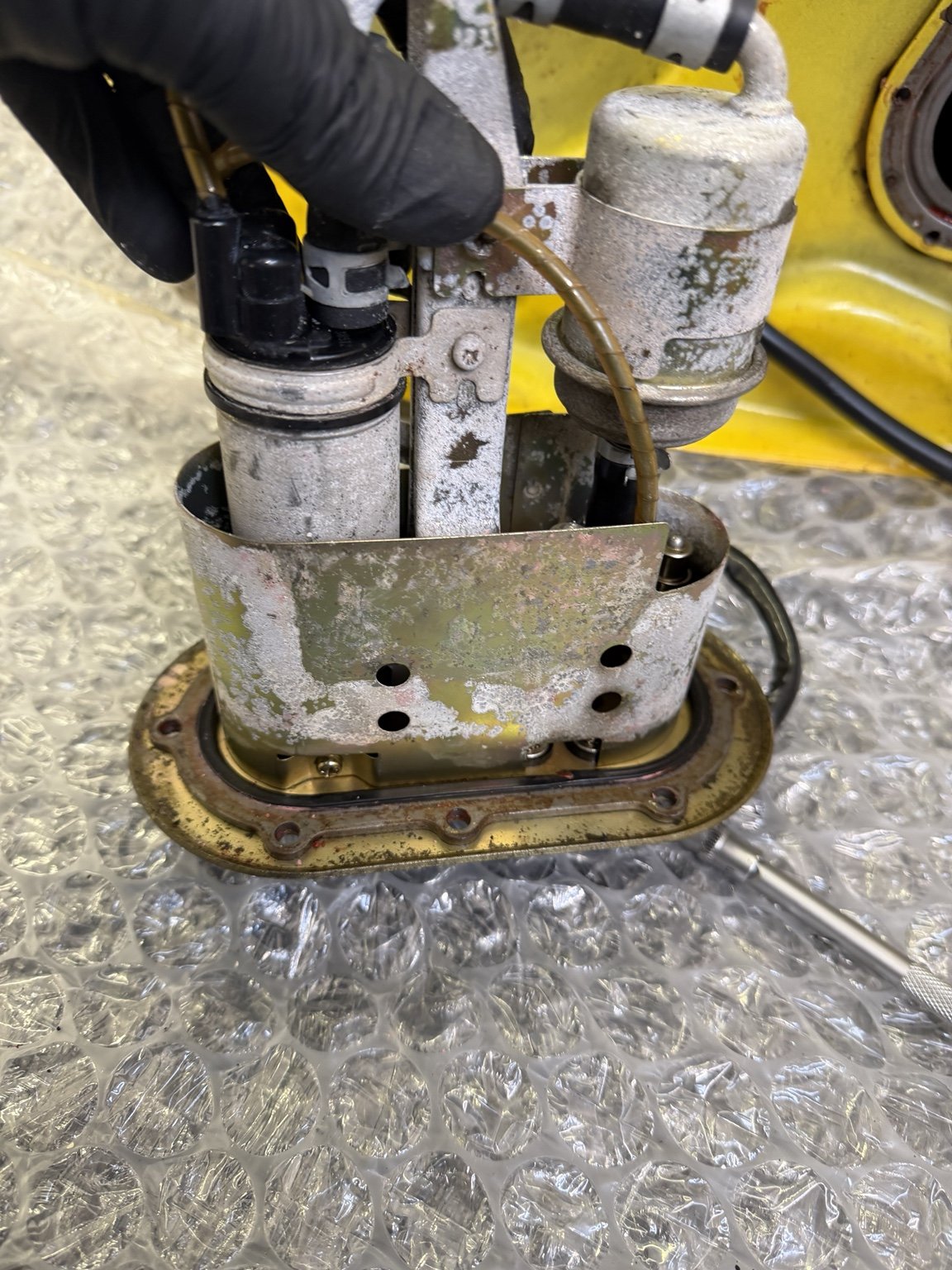 Fuel pump assembly removed from yellow Suzuki TL1000R tank